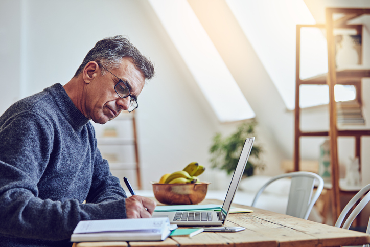 man sitting at computer at home office