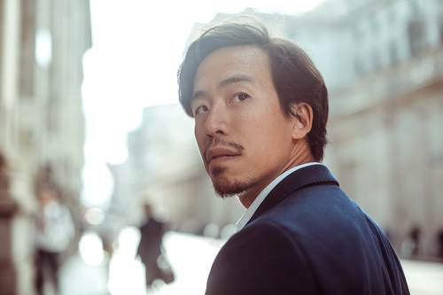 A business man looking away while thinking about recruiting in the age of AI