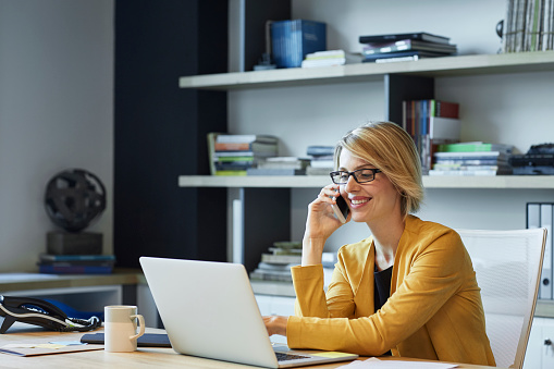 woman calling near laptop