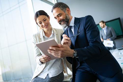 two businesspeople looking at a report