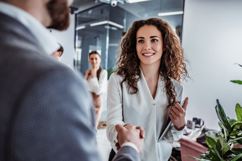 businesswoman shaking businessman's hand