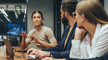 A businesswoman leading an office meeting